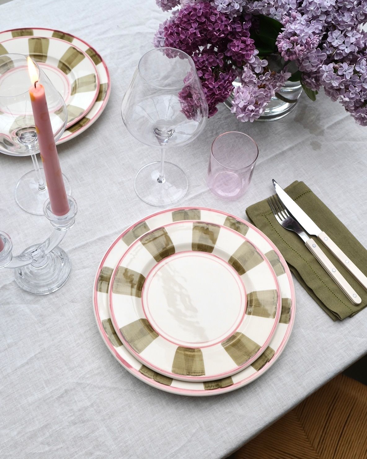 A welcoming dining table styled with plates and tableware